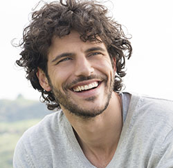 Man with curly hair smiling