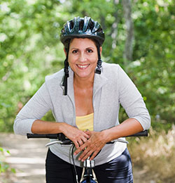 Woman smiles while out riding a bike